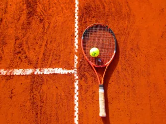 Tennis Ball on Tennis Racket on Floor