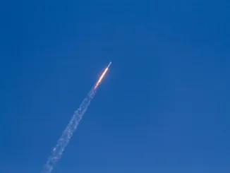 flying rocket during daytime