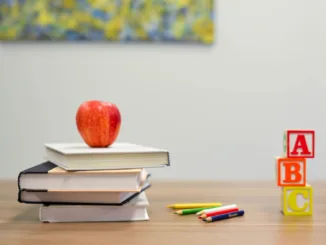 red apple fruit on four pyle books