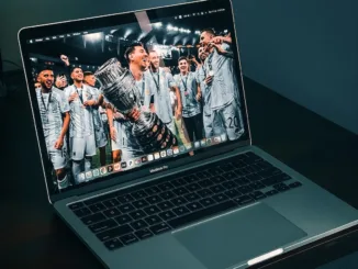 macbook pro on brown wooden table