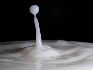 a white liquid splashing into a black background